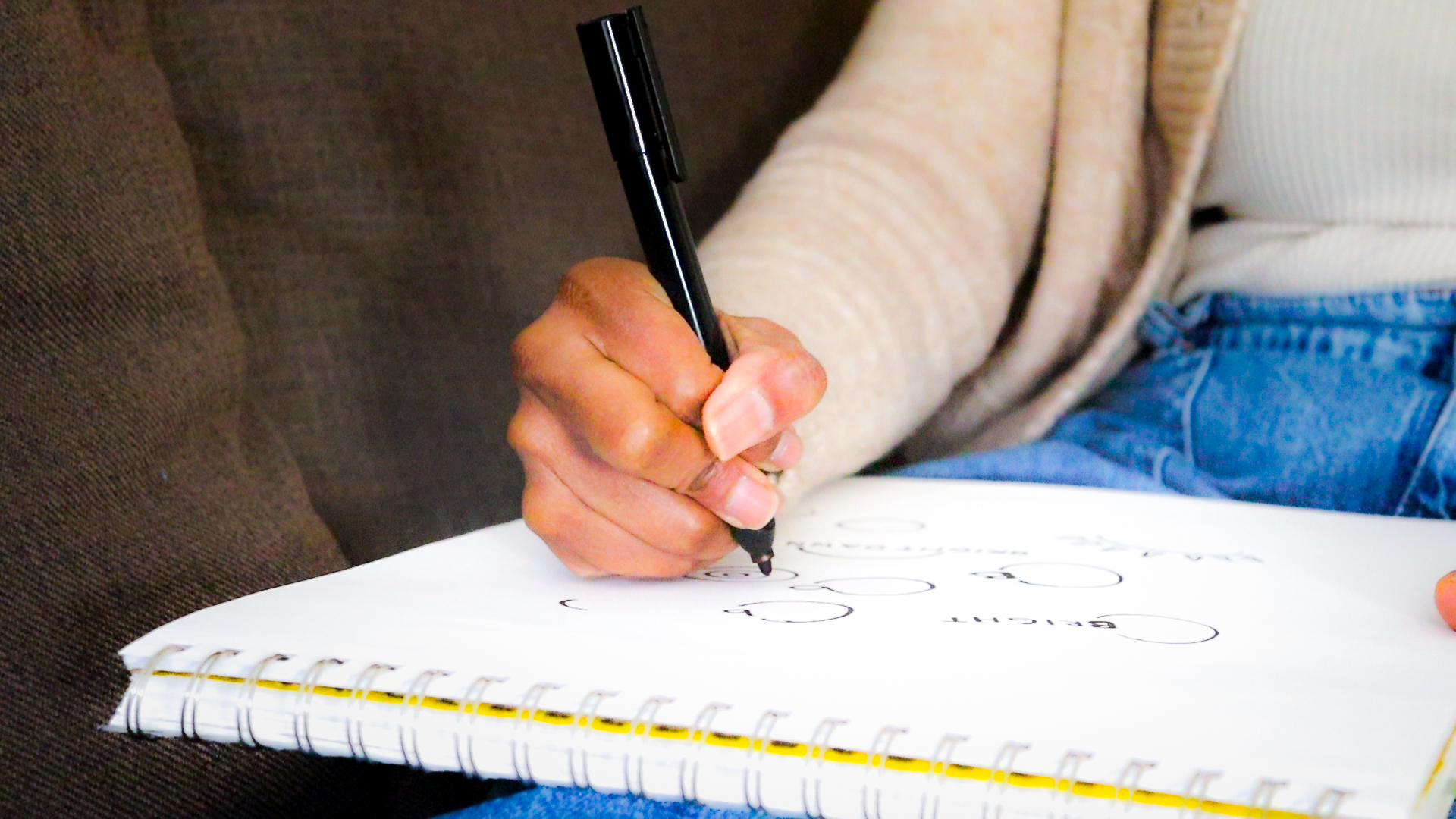 Deilia Ikuomenisan, co-founder of Ikuo Studio, sketching a logo
